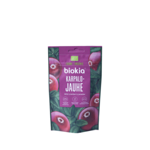 A purple package of Organic Cranberry Powder 30 g decorated with cranberry and leaf images. It displays "Luomu Organic" and "Karpalo Jauhe," plus icons for organic certification and nutrition facts.