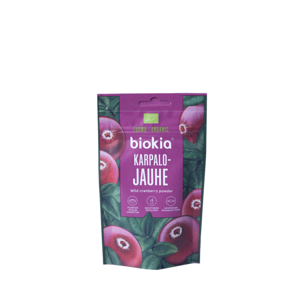 A purple package of Organic Cranberry Powder 30 g decorated with cranberry and leaf images. It displays "Luomu Organic" and "Karpalo Jauhe," plus icons for organic certification and nutrition facts.