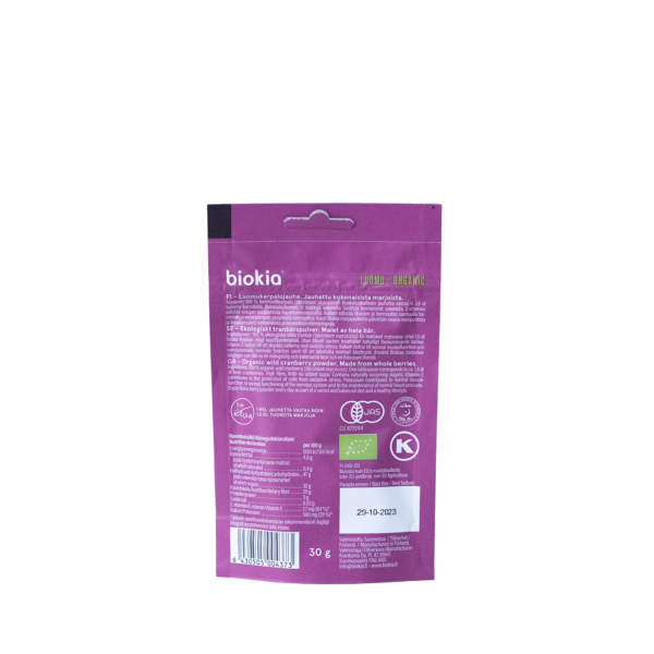 The image shows the reverse side of a Biokia Organic Cranberry Powder 30 g package in purple and pink. It includes Finnish text, several certification logos, and has the date 29-10-2023 printed at the bottom.